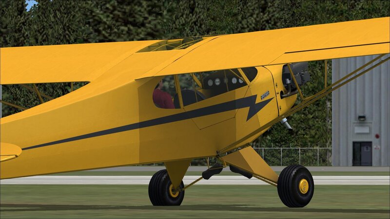 yellow biplane on runway