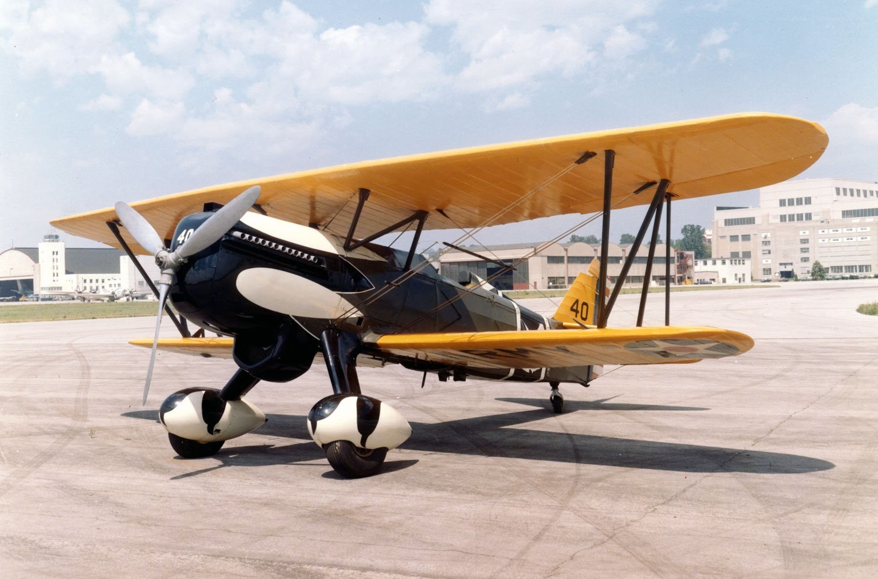 yellow biplane on tarmac