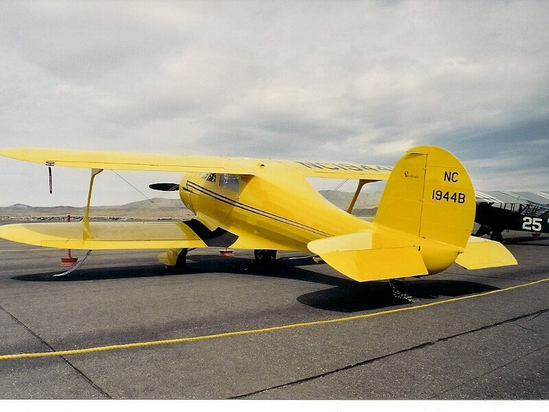 Yellow Biplane on Tarmac — Calm, Afternoon, Photograph, Airplane