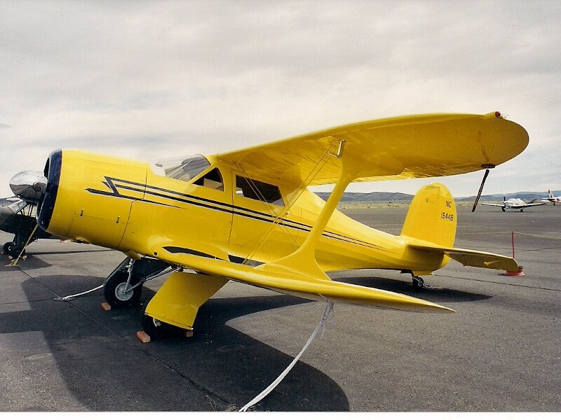 Yellow Biplane on Tarmac — Calm, Afternoon, Photograph