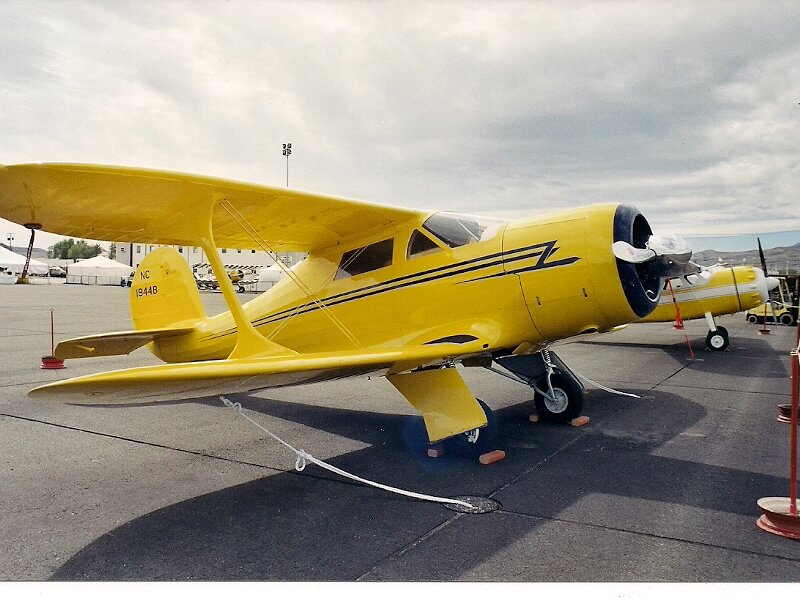 Yellow Biplane on Tarmac — Calm, Afternoon