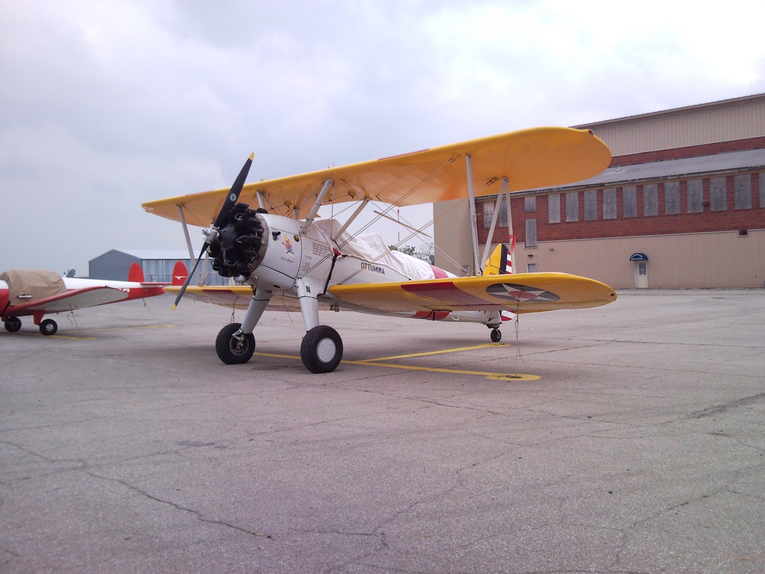 Yellow biplane on tarmac
