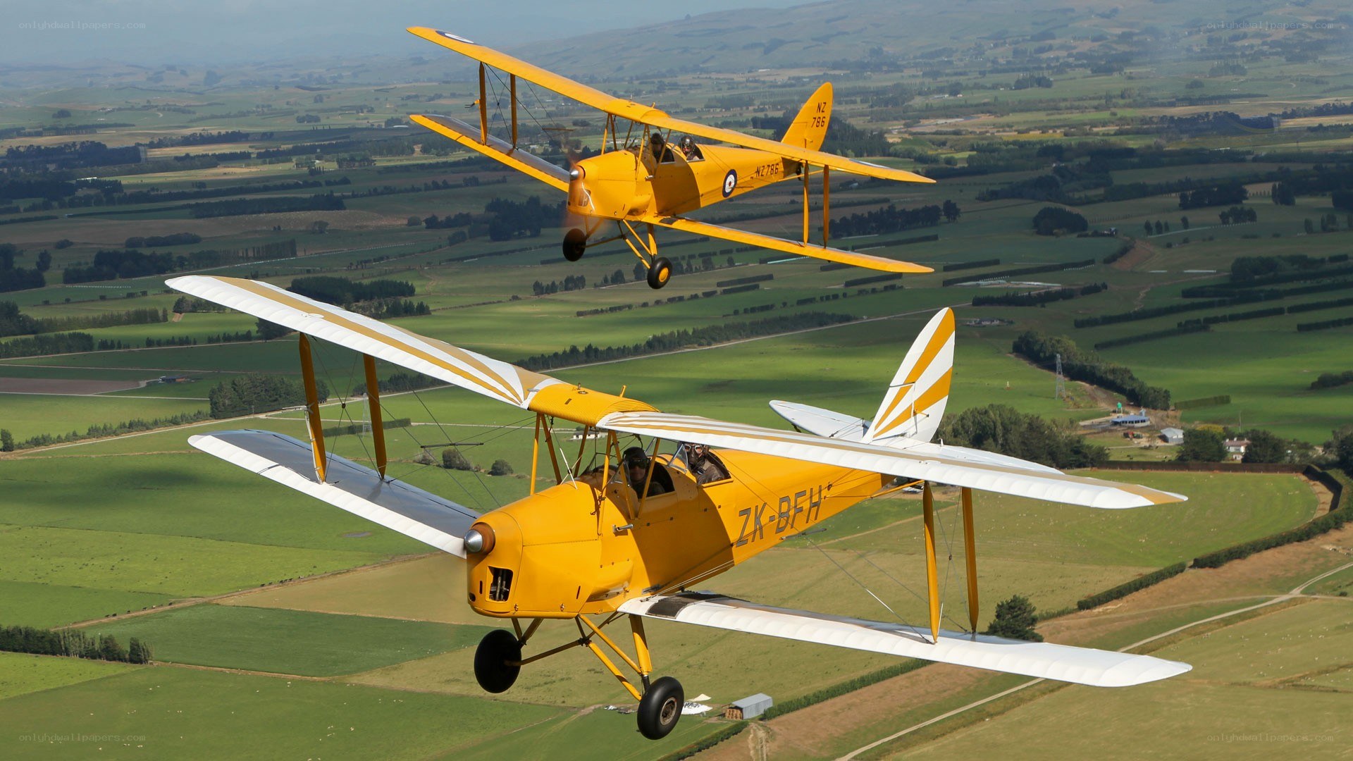Yellow biplanes in flight