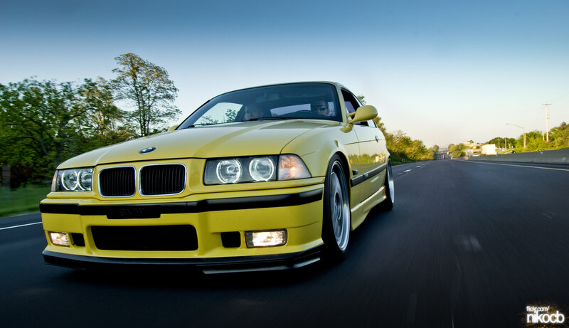 yellow bmw driving on road
