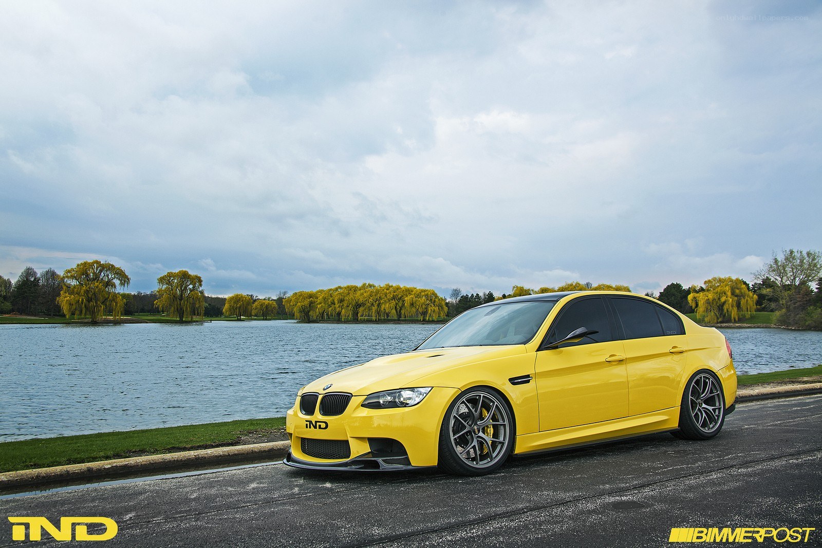 Yellow BMW M3 by a lake