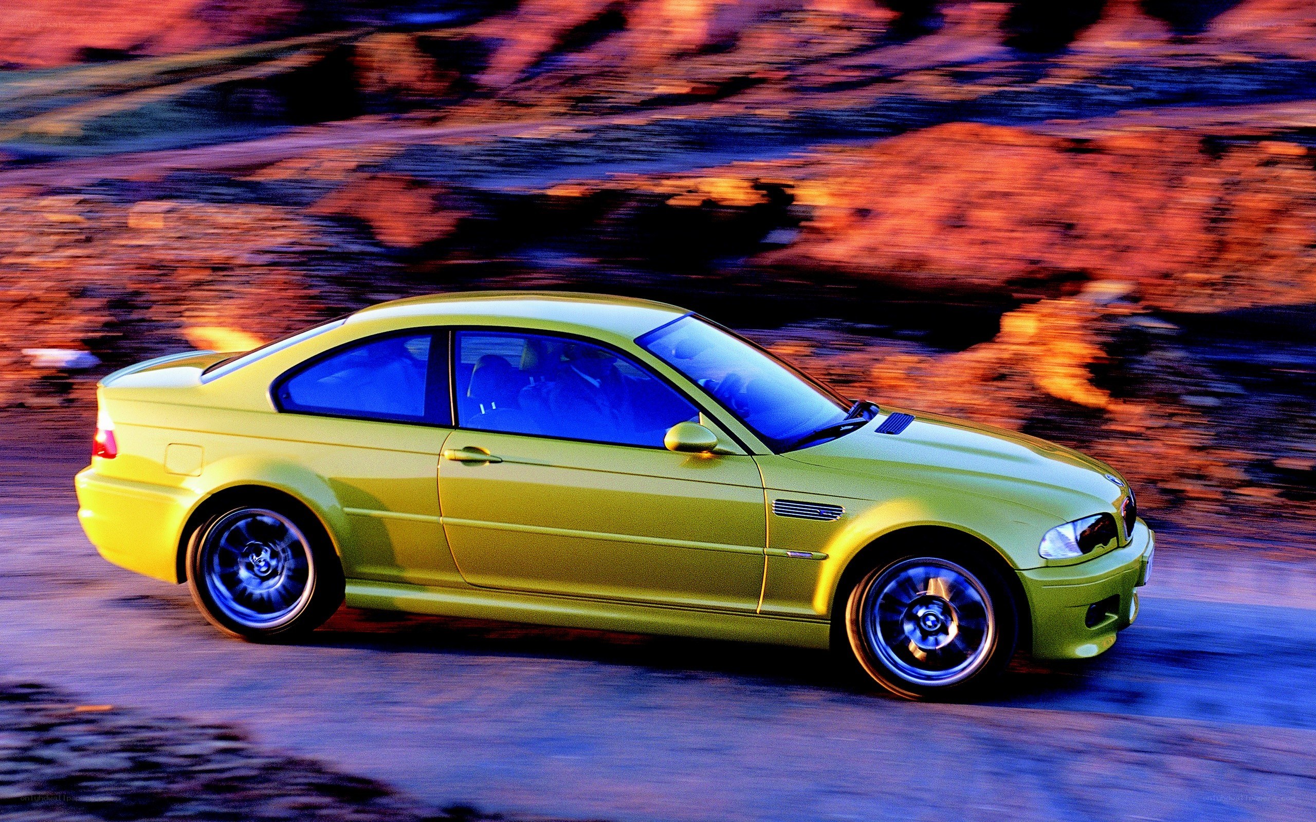 yellow BMW M3 in motion