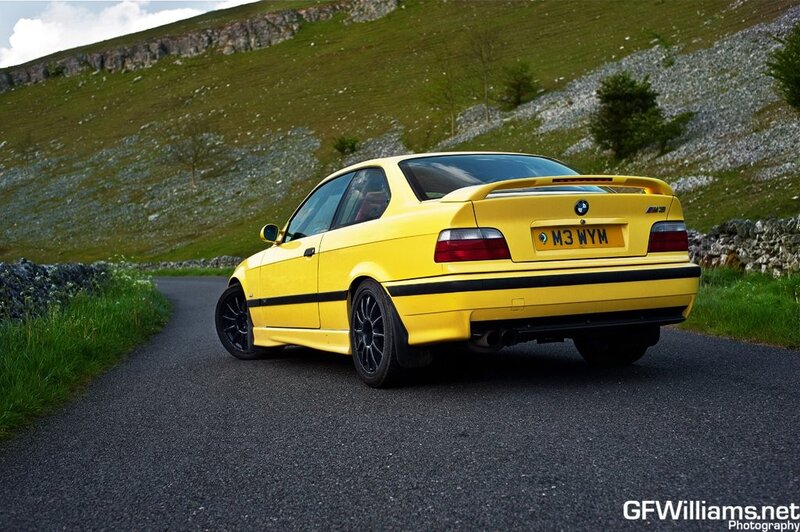 Yellow BMW M3 on a country road
