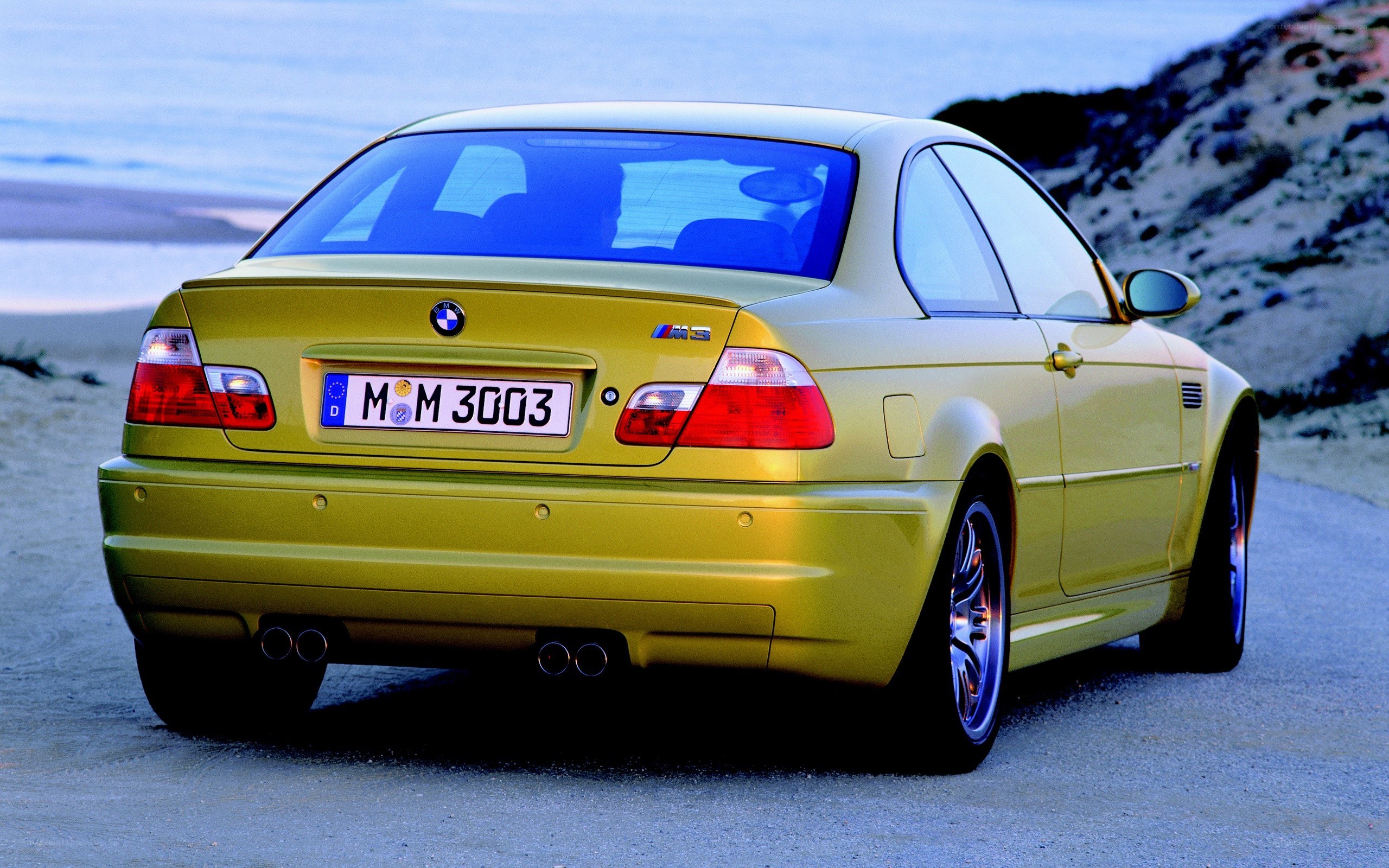 yellow bmw m3 on beach