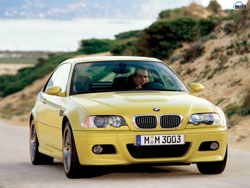 yellow bmw m3 on coastal road