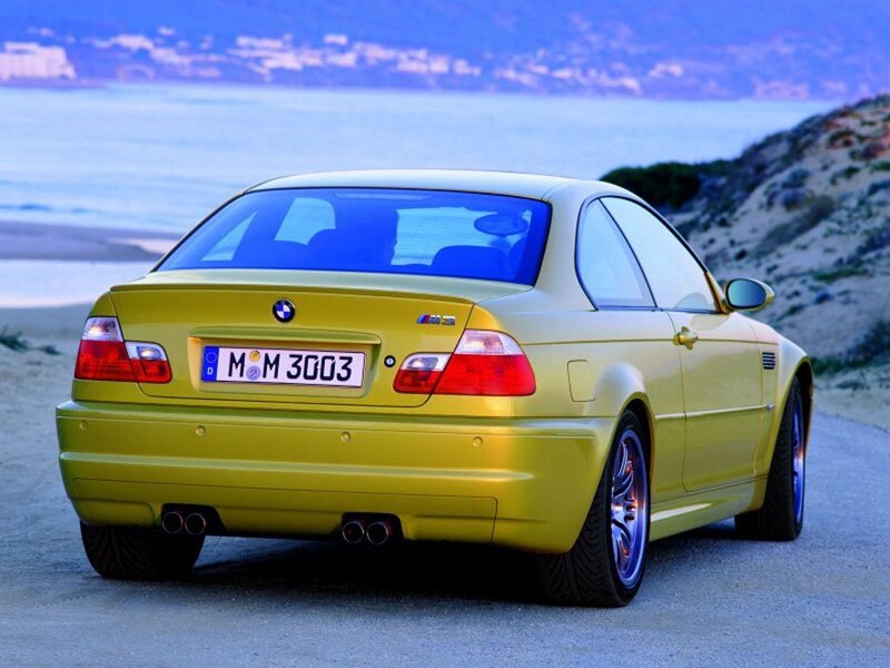yellow bmw m3 on coastal road