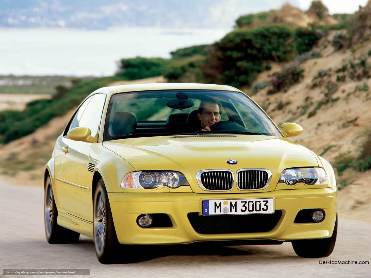 Yellow BMW M3 on coastal road