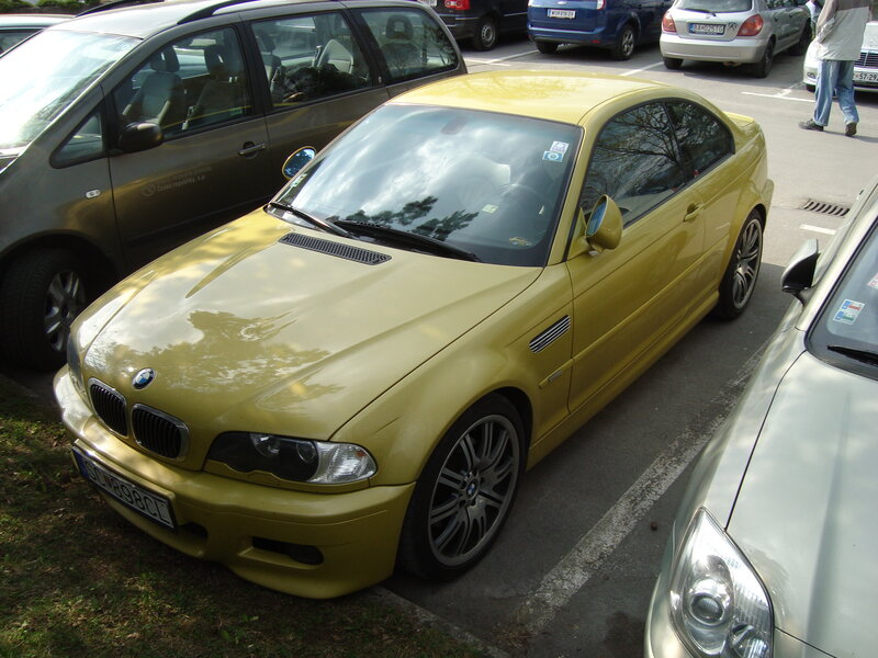 yellow bmw m3 parked in lot