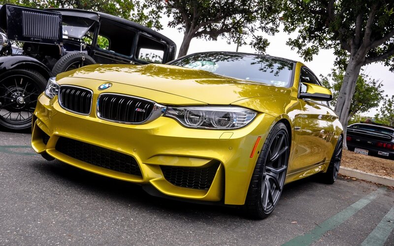 Yellow BMW M4 at car show