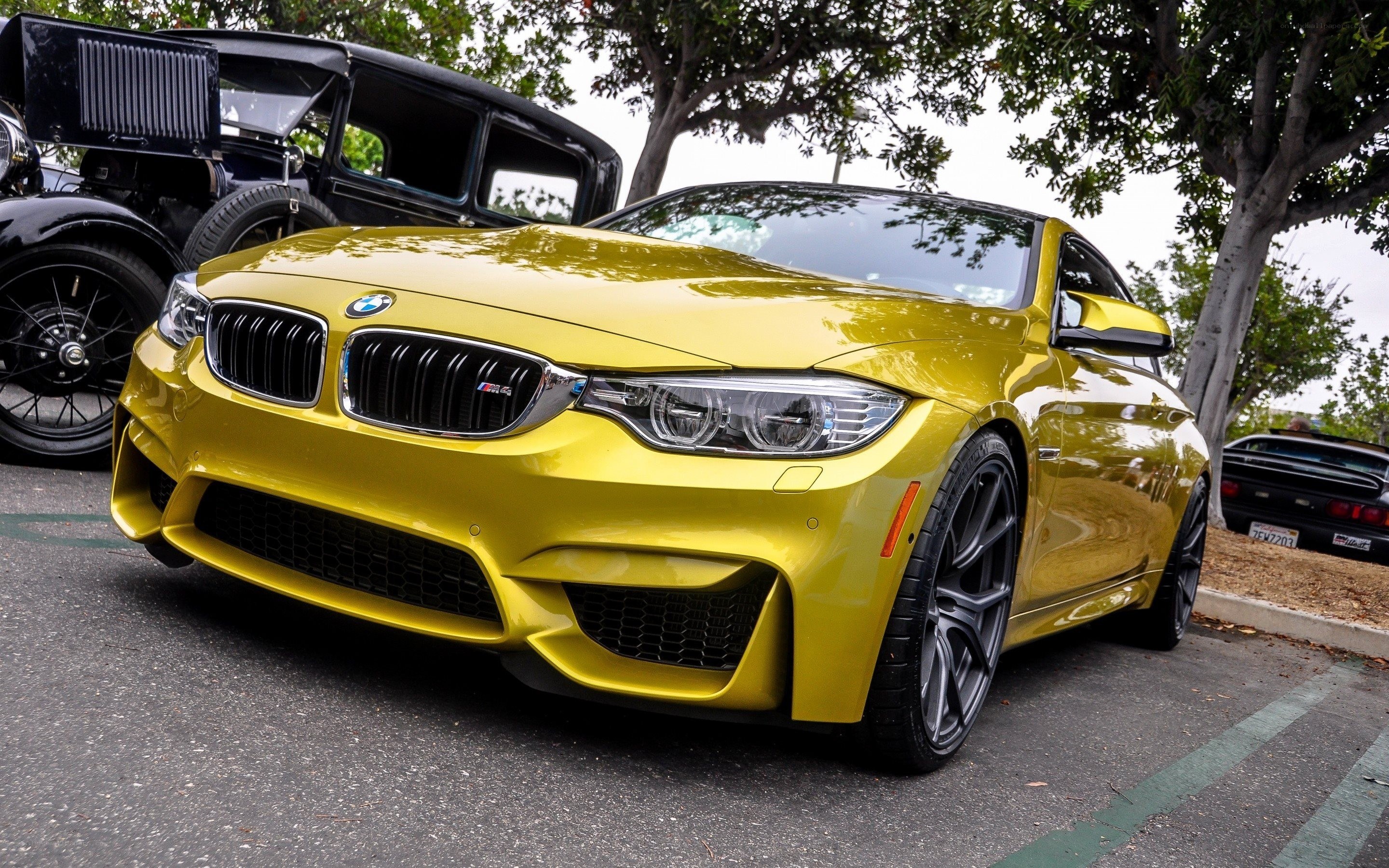 Yellow BMW M4 at car show