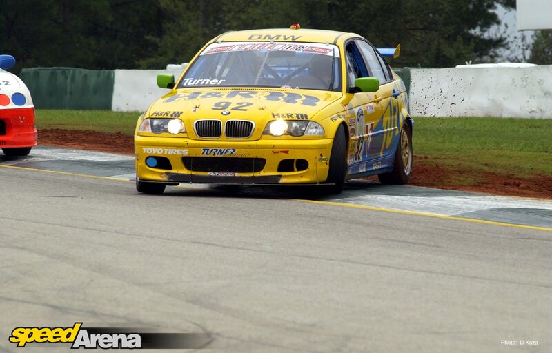 Yellow BMW race car on track