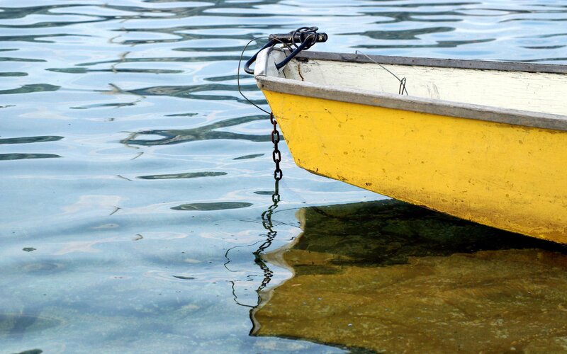 yellow boat on calm water