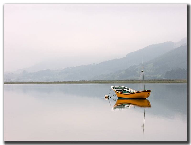 Yellow boat on calm water