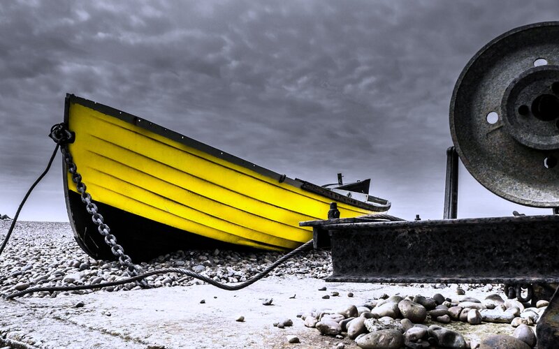 Yellow Boat on Pebble Beach