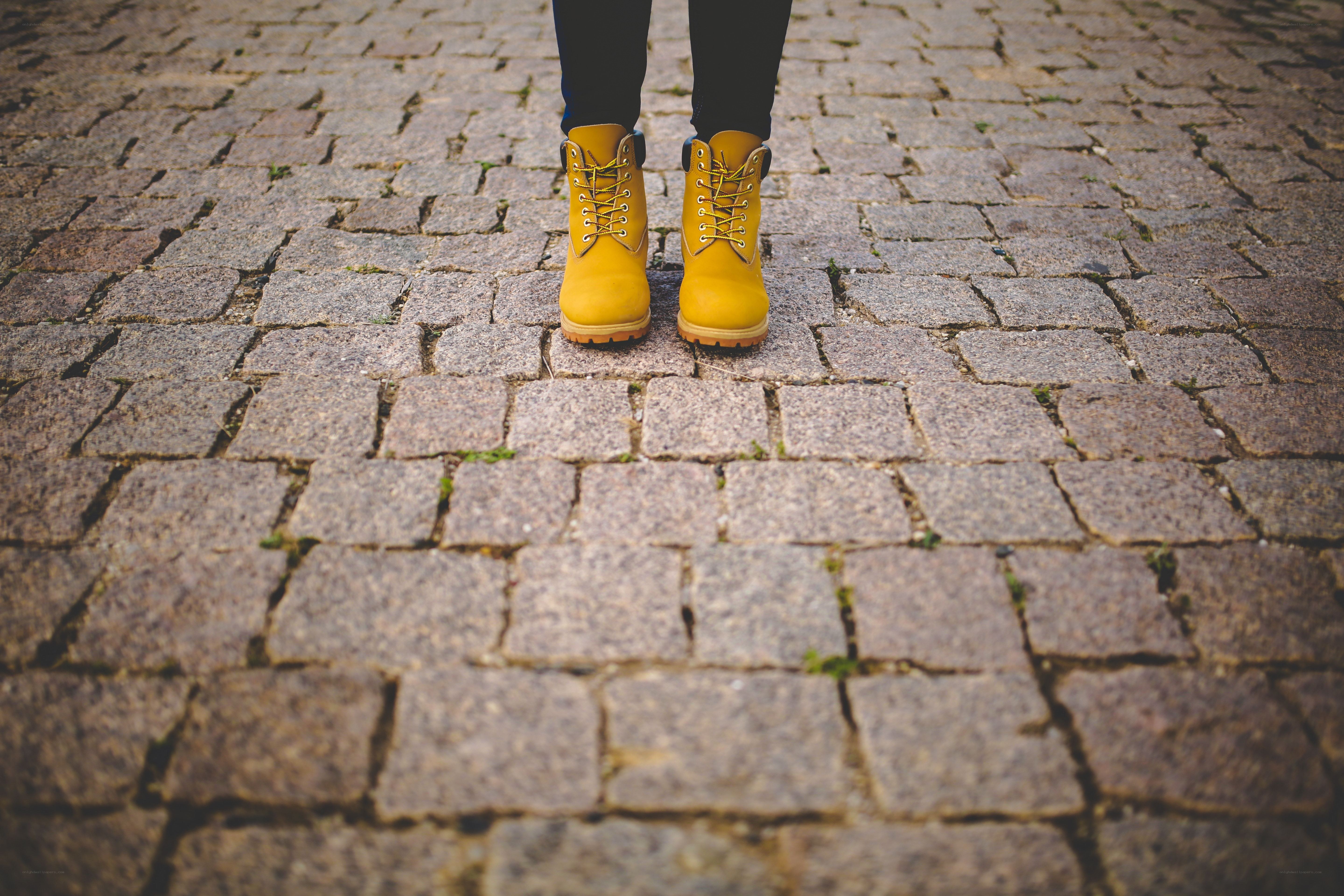yellow boots on cobblestones