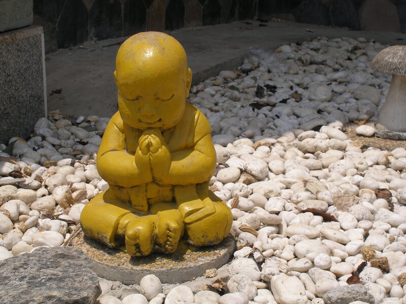 Yellow Buddha statue in garden