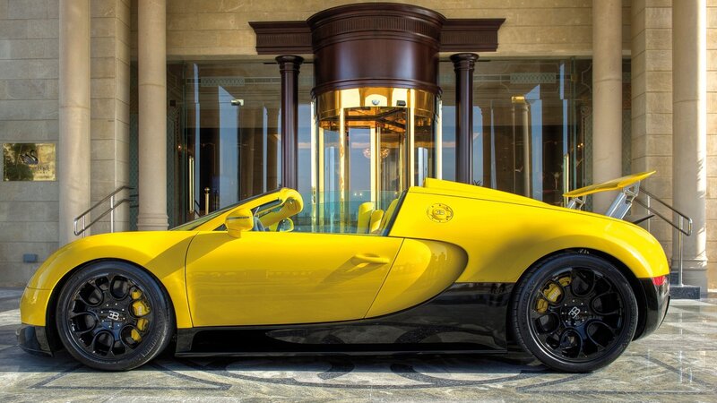 Yellow Bugatti Veyron at hotel entrance