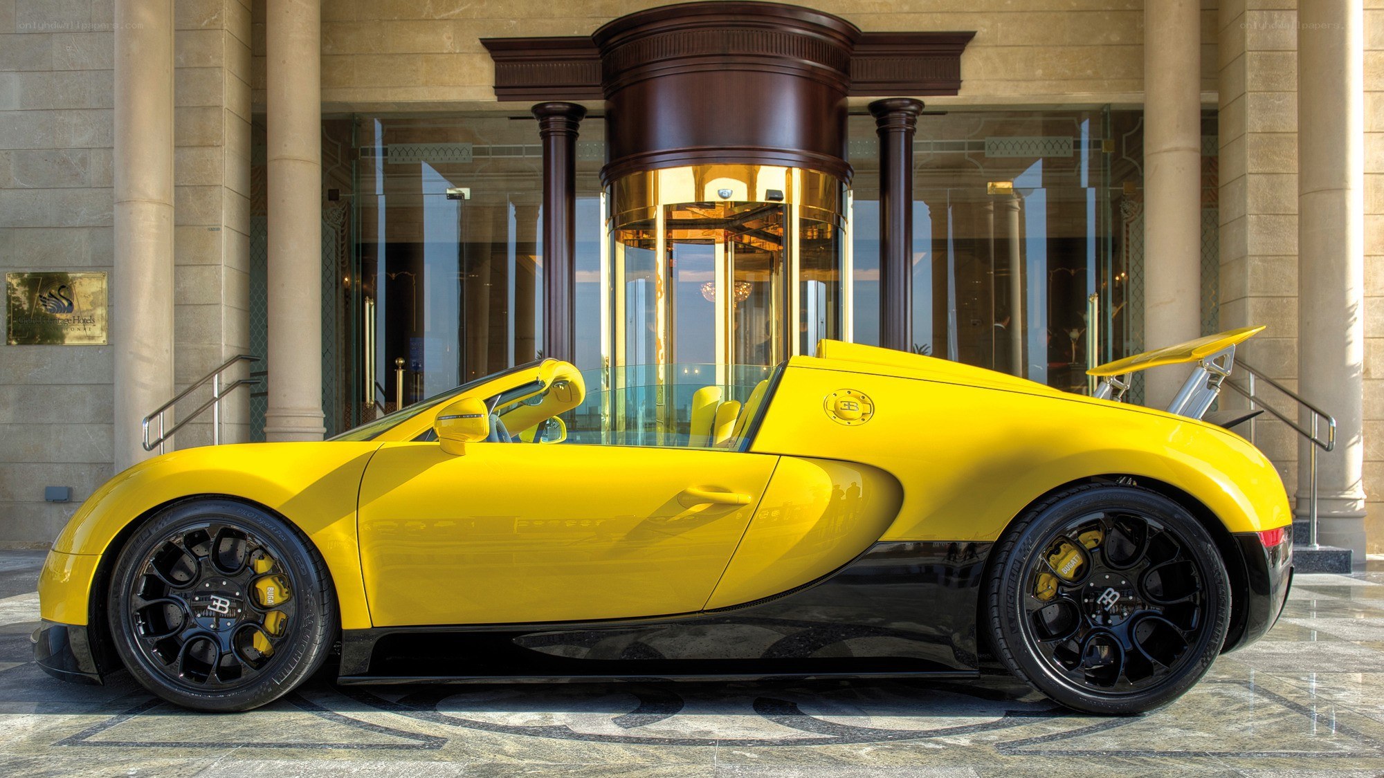 Yellow Bugatti Veyron outside hotel