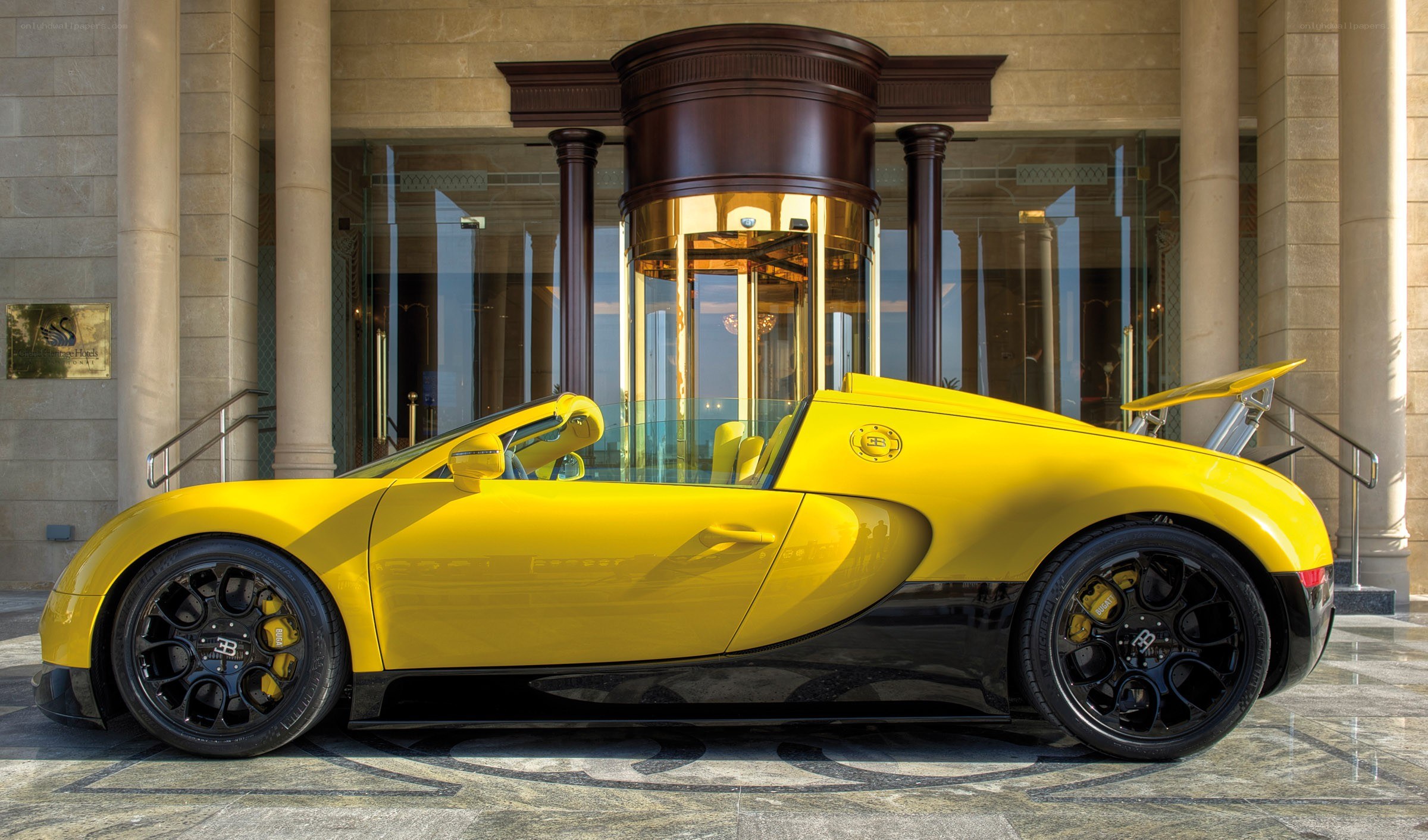 Yellow Bugatti Veyron parked outside