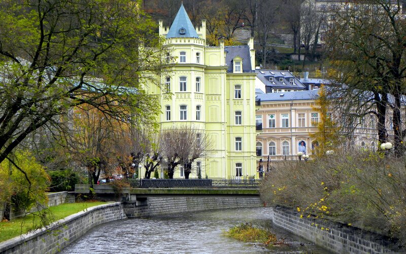 Yellow building by a river