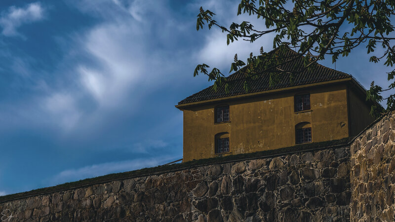 Yellow Building on Stone Wall