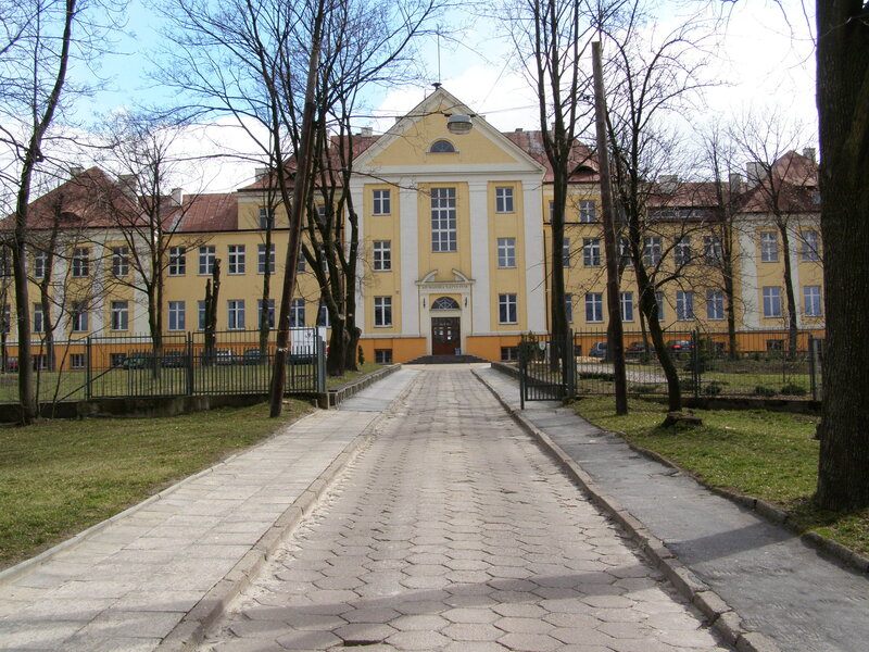 yellow building with paved walkway