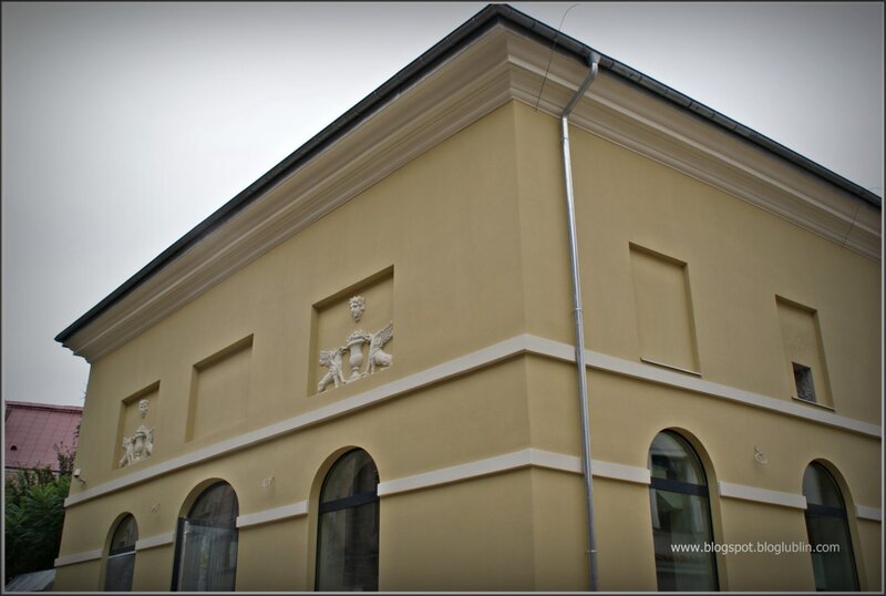 yellow building with sculptures
