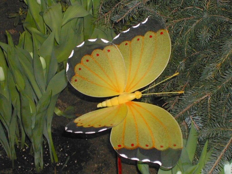 Yellow butterfly sculpture in garden