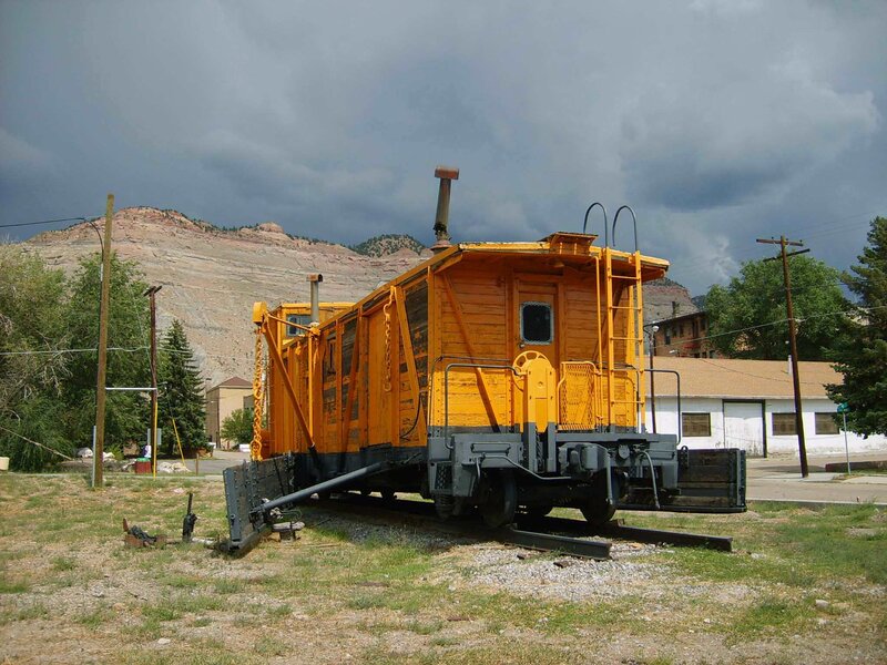 Yellow caboose in a mountain town