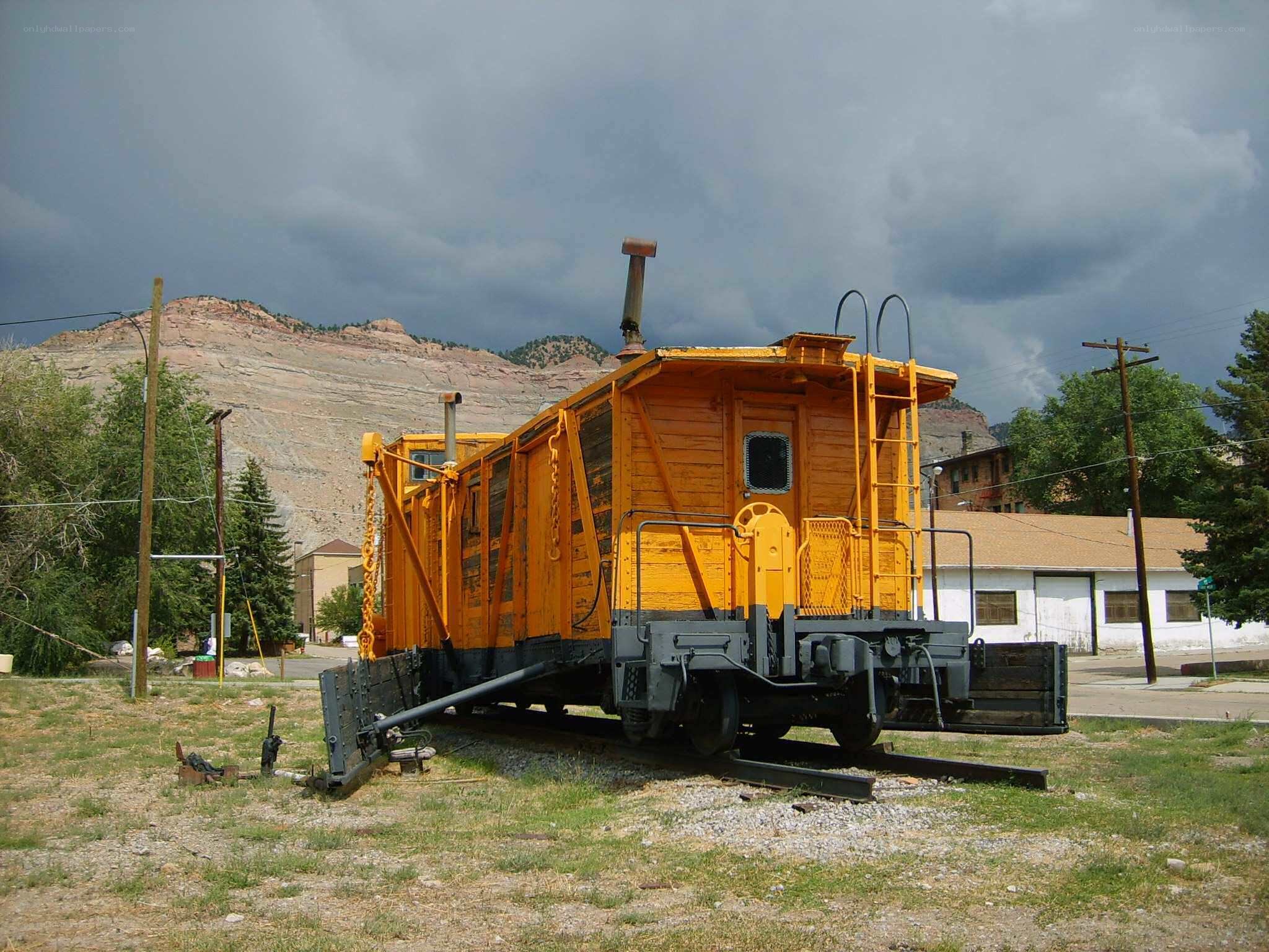 Yellow caboose in a mountain town