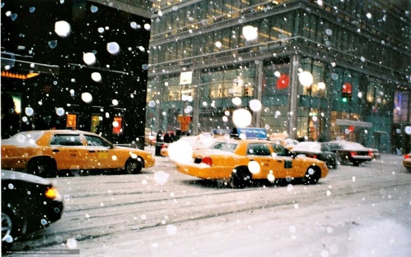 Yellow cabs in snowy city