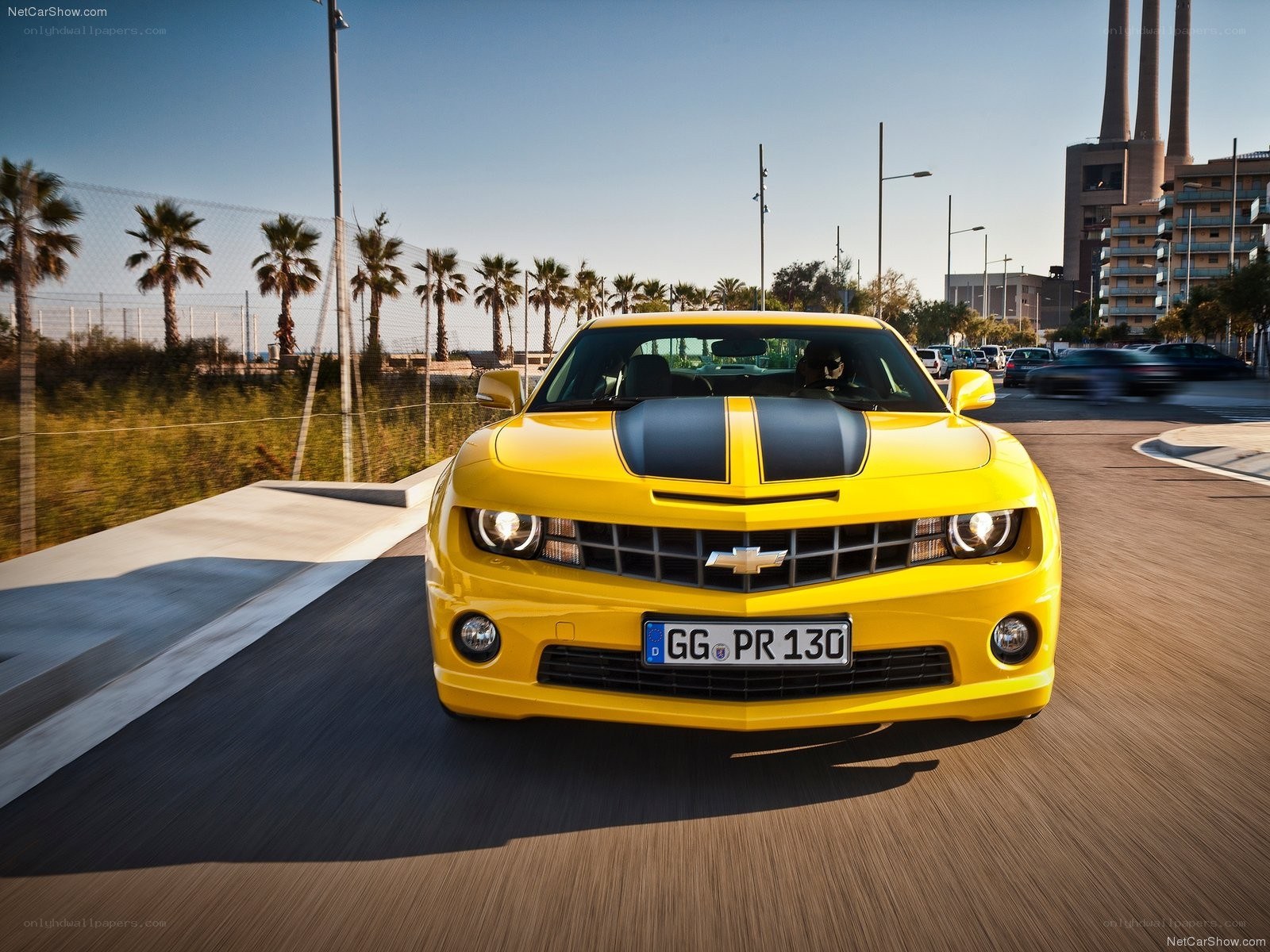 Yellow Camaro driving on road