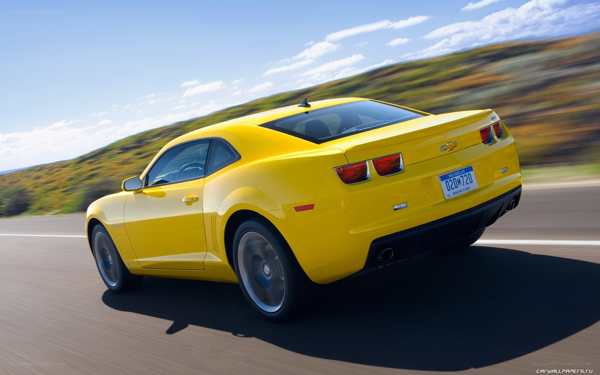 yellow camaro driving on road