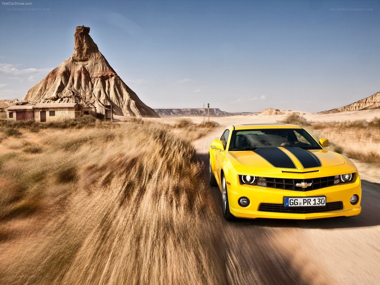 Yellow Camaro in desert landscape