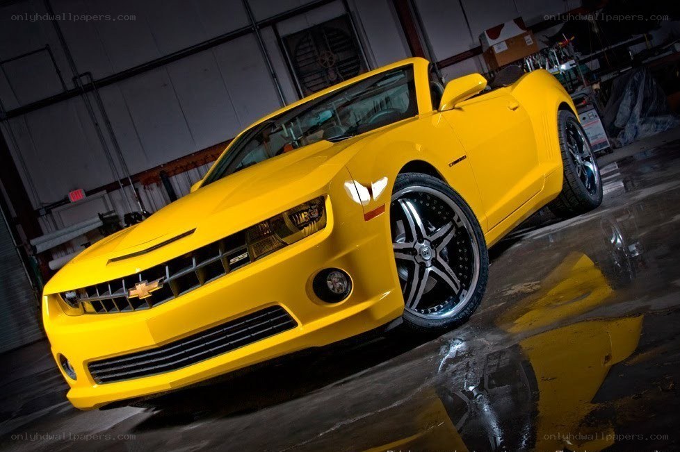 Yellow Camaro in garage