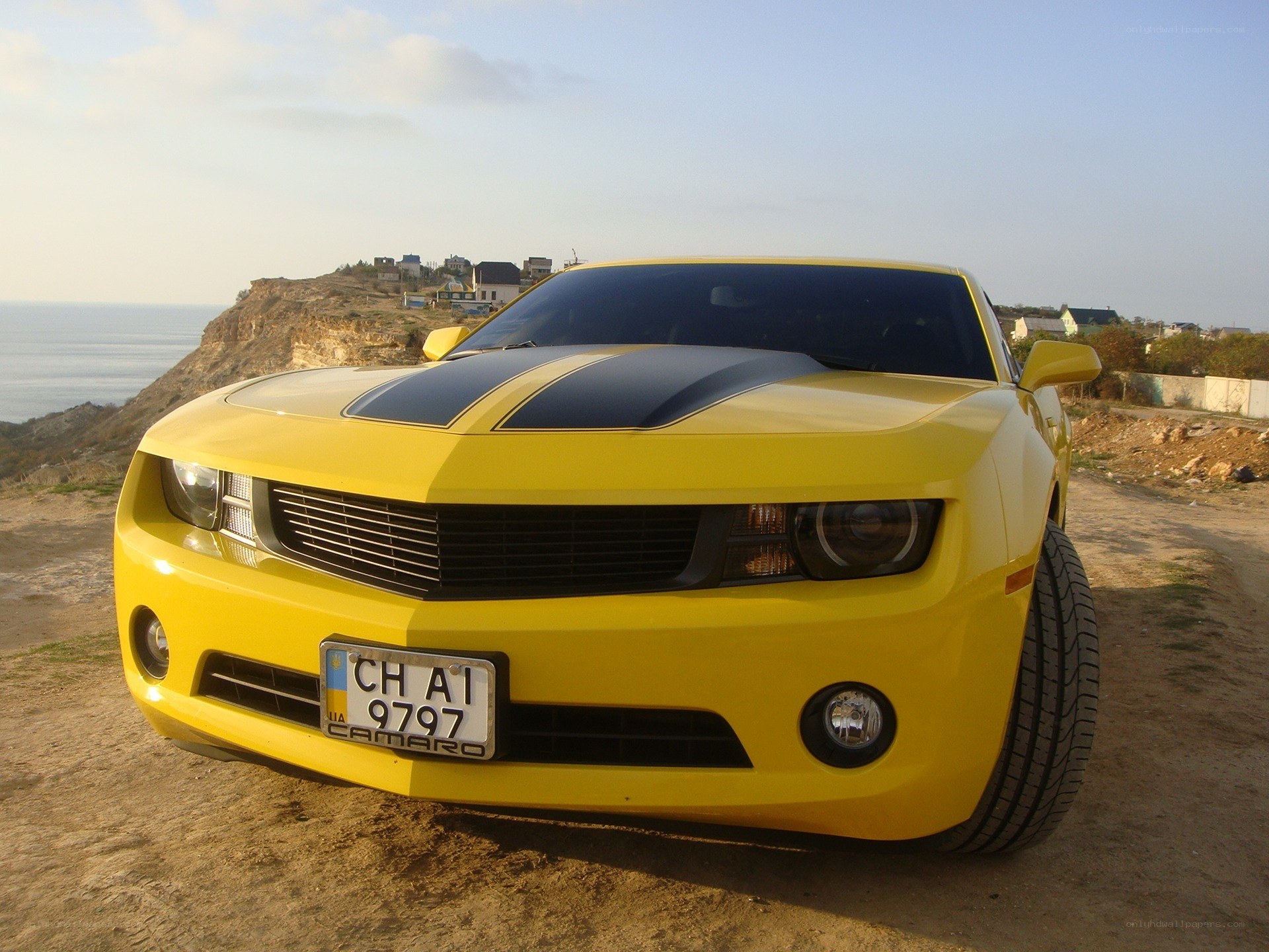 Yellow Camaro on cliffside