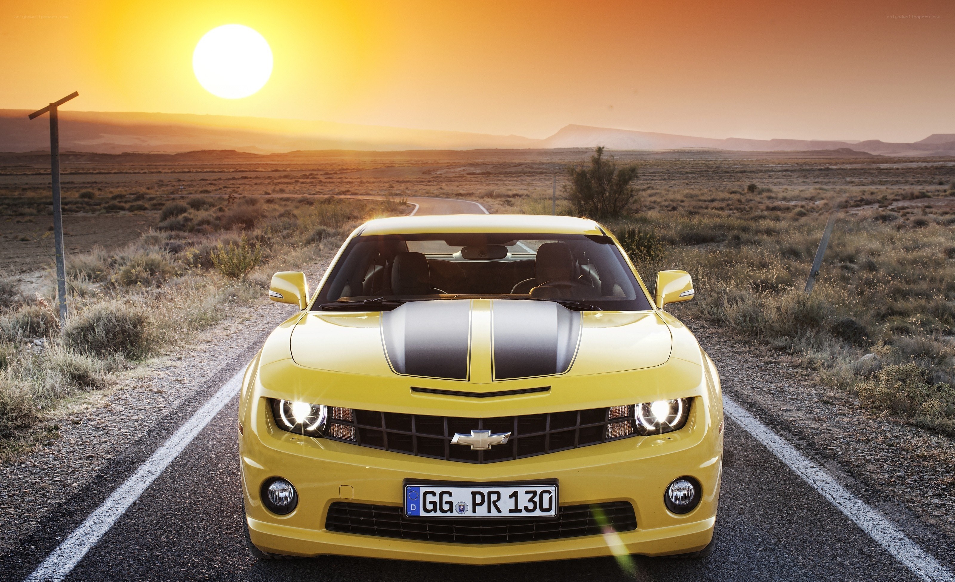 Yellow Camaro on desert road