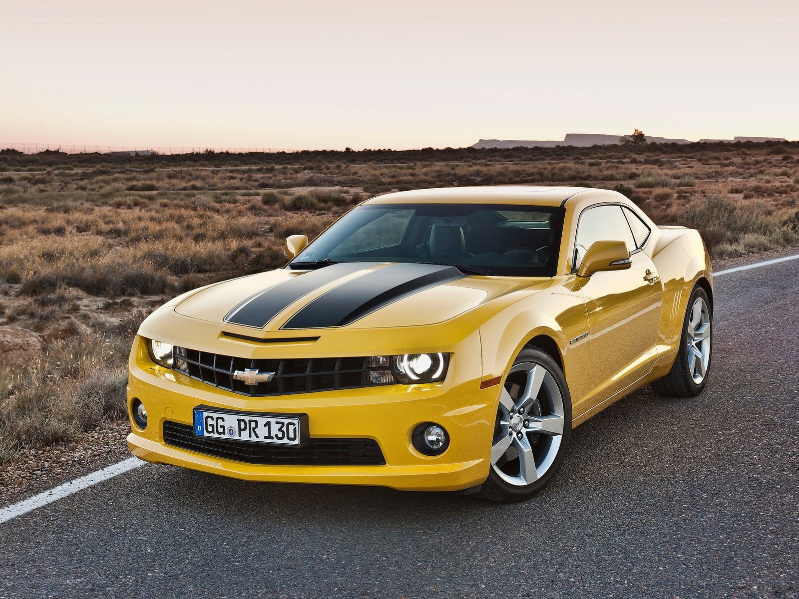 Yellow Camaro on desert road