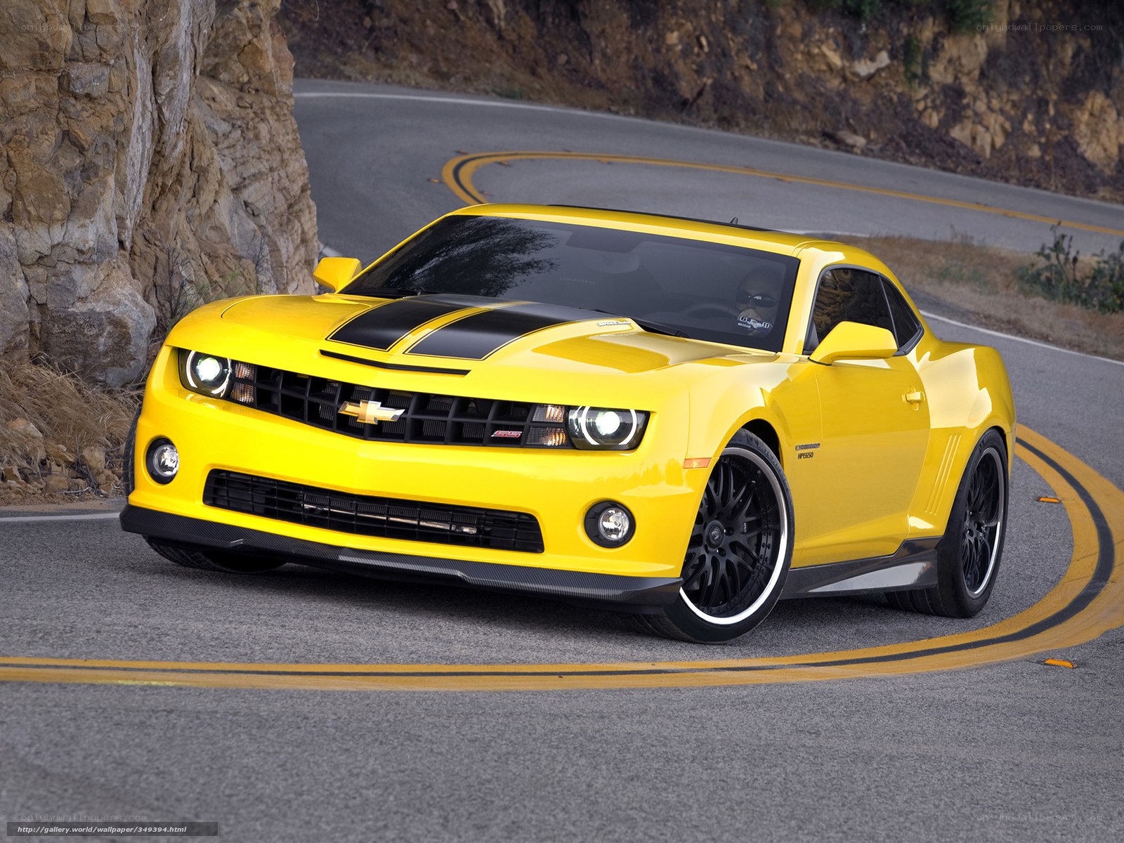 Yellow Camaro on winding road