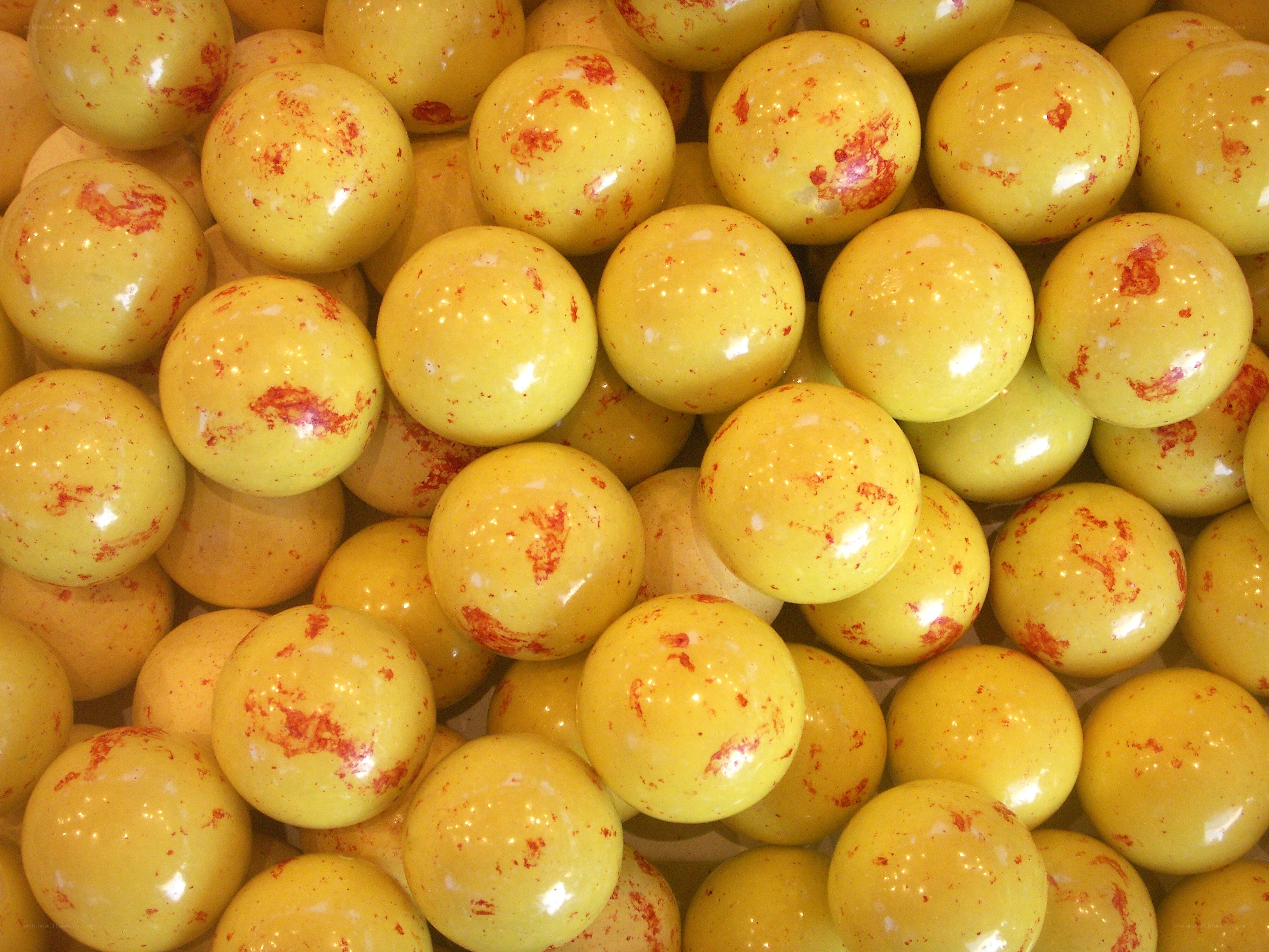 yellow candy balls with red speckles
