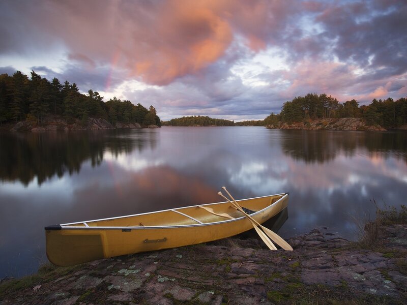 Yellow Canoe on Shore — Serene, Sunset