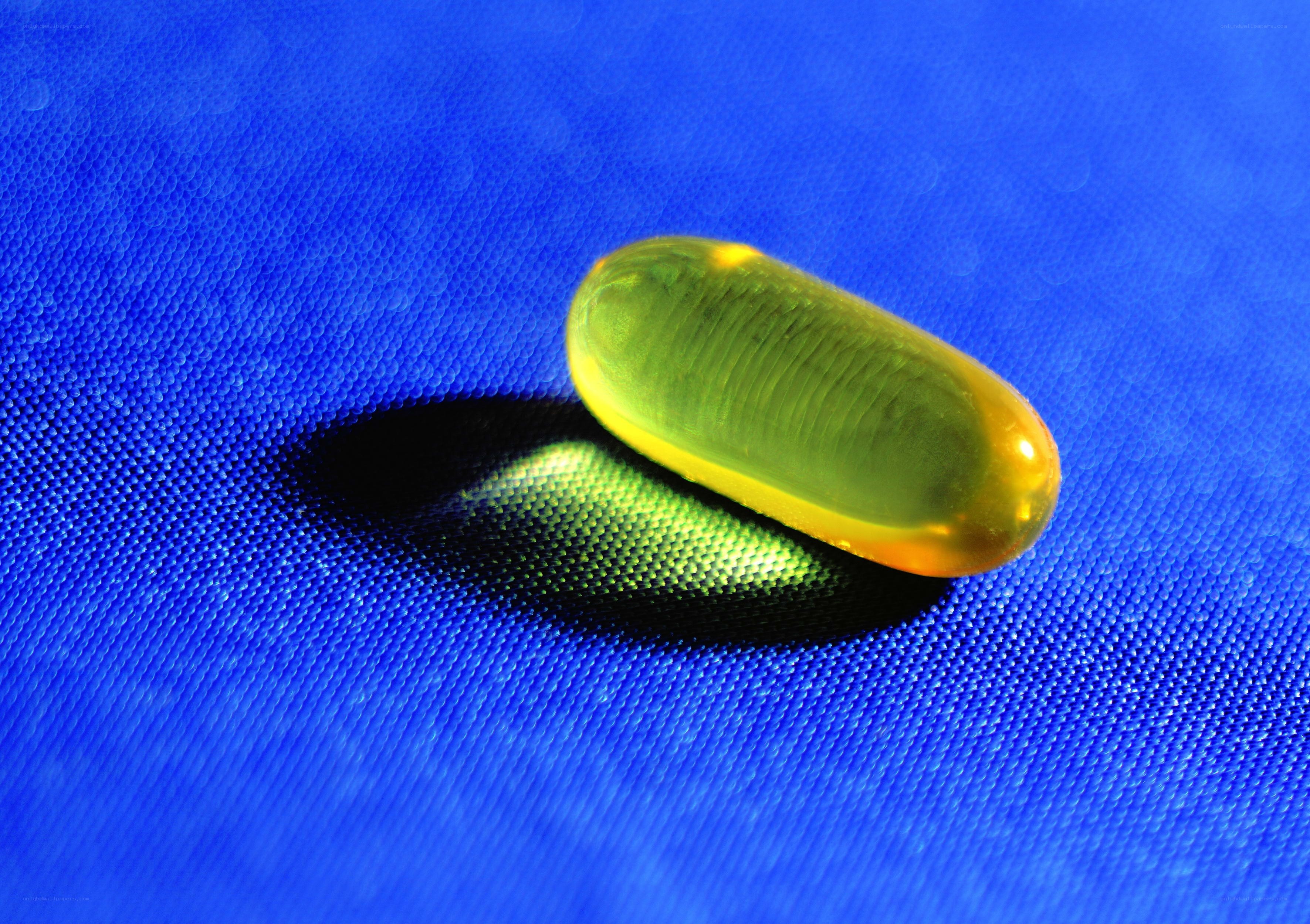 Yellow capsule on blue fabric
