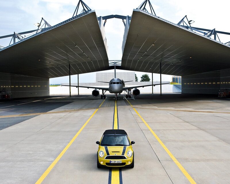 Yellow car at airport hangar