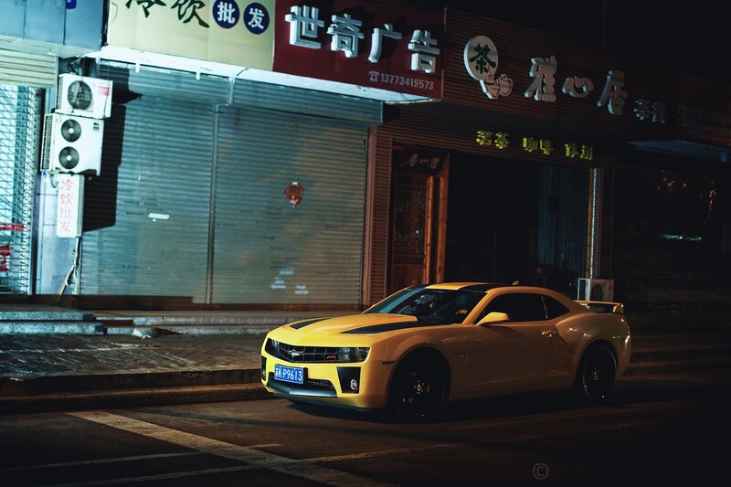 Yellow car at night on street