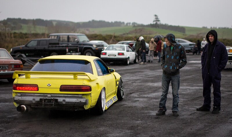 Yellow car at outdoor gathering