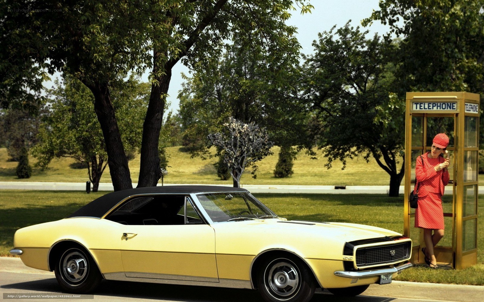 Yellow car at phone booth